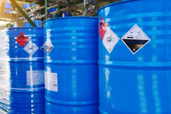 Flammable, acid, volatile, warning labels, mounted on hazardous Waste Storage Drums